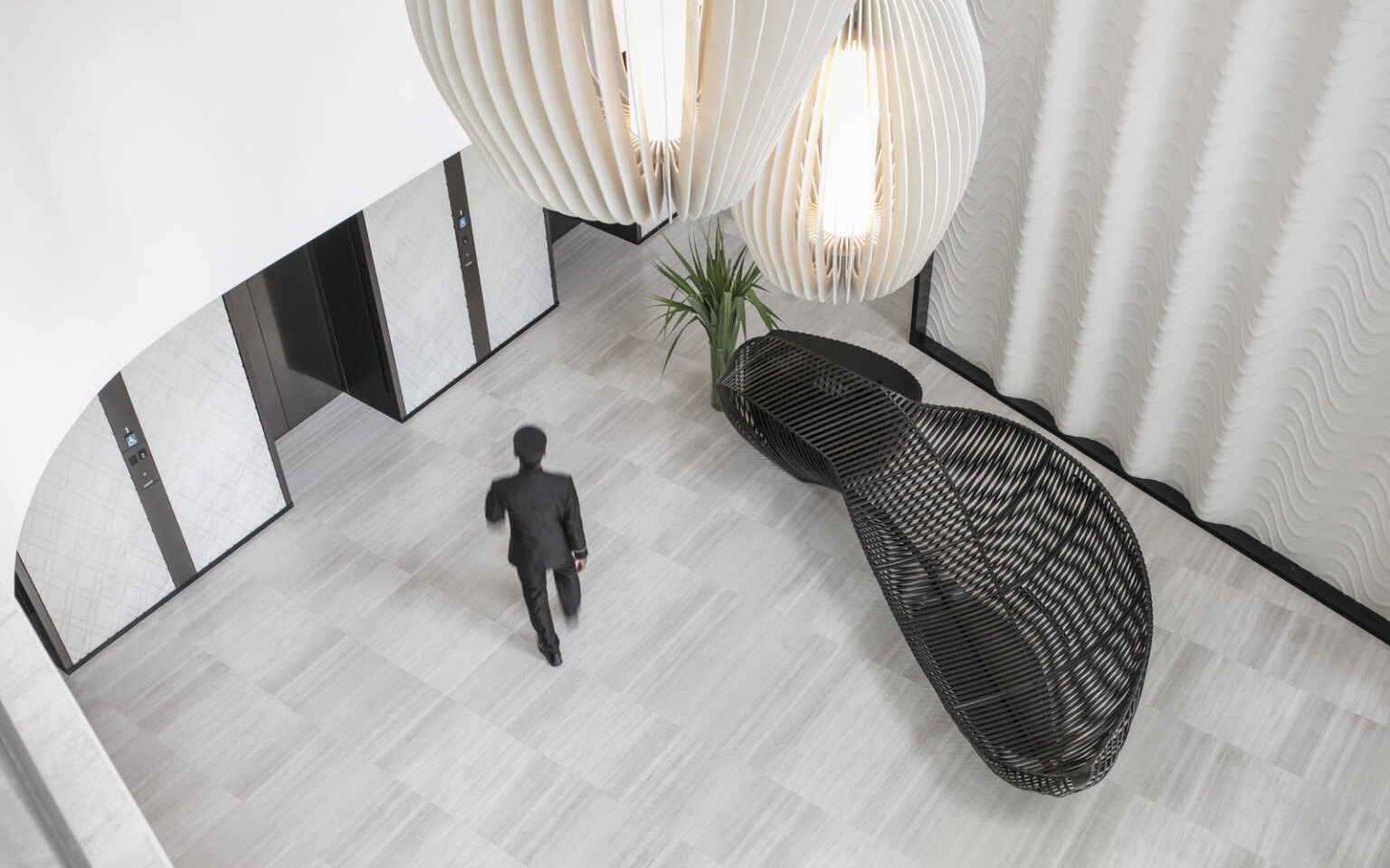 sr singapore ascott orchard lift lobby with staff walking hr